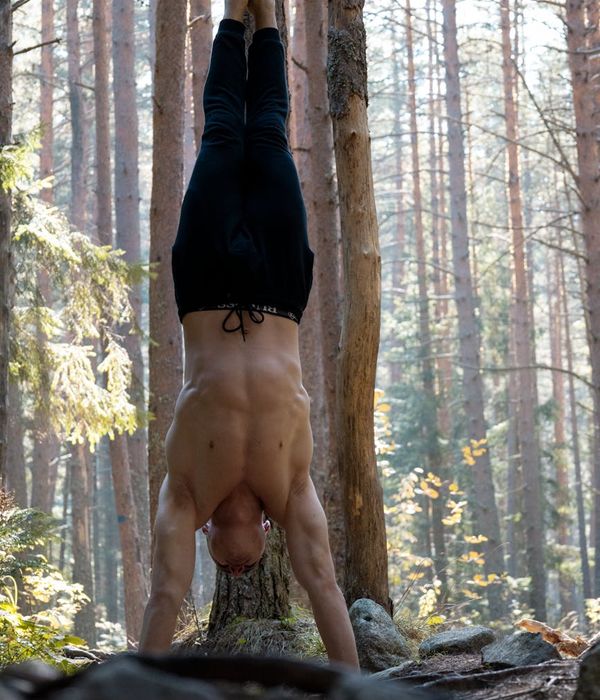 Focused man performing a controlled bodyweight exercise in a minimalist setting.